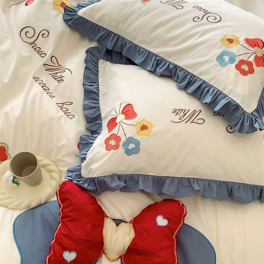 Ruffled Quilted Bedding Set with Embroidered Flower Appliqués and Decorative Bow Cushions
